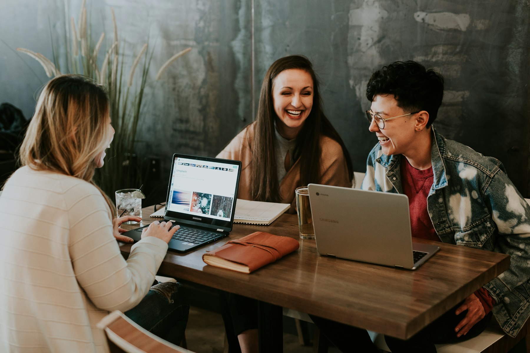 Group of people working around a laptop