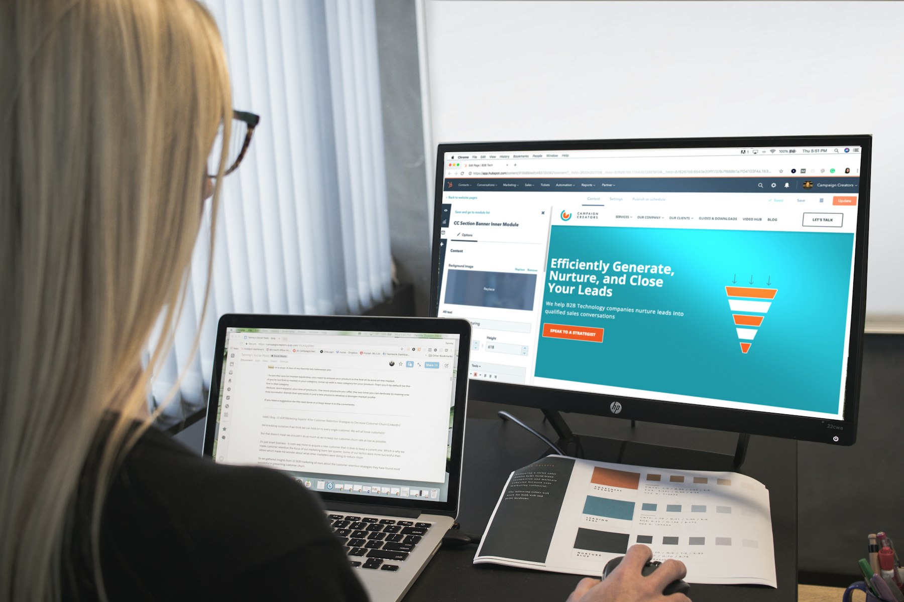 Woman working on a website at a large monitor